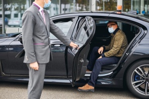 Chauffeur,Opening,The,Car,Door,For,A,Caucasian,Male,Passenger